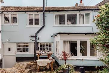 Welcome to Potters Cottage. Two steep steps lead down from the shared courtyard to the stable door.
