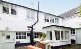 Behind the bay window is the outhouse, where there is a washing machine. Please note,  Two steep steps lead down from the shared courtyard to the stable door.  - Thumbnail Image