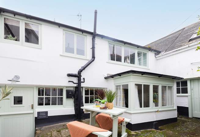 Behind the bay window is the outhouse, where there is a washing machine. Please note,  two steep steps lead down from the shared courtyard to the stable front door. 