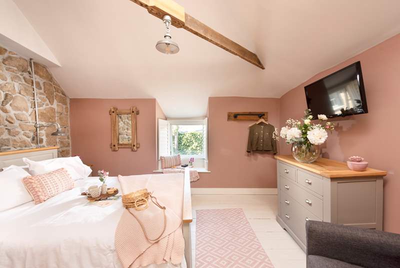 The gorgeous bedroom is tastefully decorated to complement the original stone walls. Please note there is no longer a TV in the bedroom.