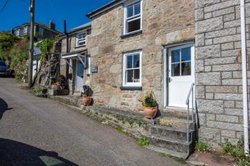 Perched on a hill within the heart of the picturesque harbourside village of Mousehole, charming Thimble Cottage is a stunning retreat with sea views from every room.