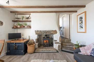 Three steps lead down from the kitchen into the open plan sitting/dining area.