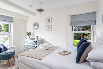 The second bedroom is lovely and light with a double bed and a blissful space to relax with a good book while the sunshine streams in.