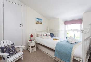 The colourful third bedroom has a single bed and a trundle bed (Smugglers accommodates five with flexibility of beds), perfect for children. 