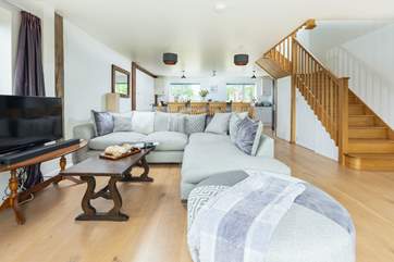 The relaxing living space with feature oak staircase.