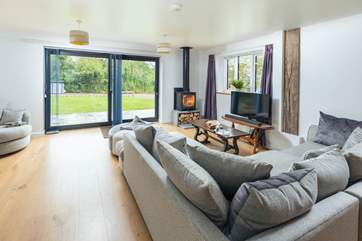 The fabulous living-room has a super-comfy corner sofa and patio doors to the garden.
