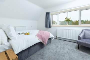 Bedroom 5 fills with light from the room length windows and is beautifully decorated in muted shades.