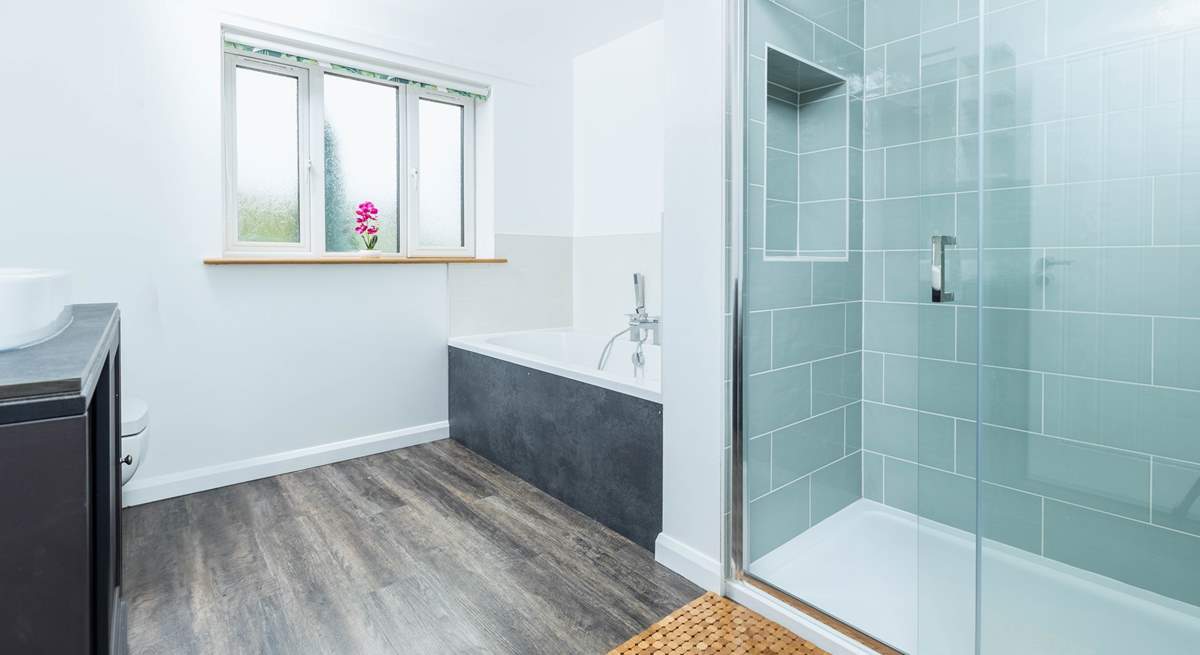 Bathroom 1 is beautifully created with both a walk-in shower and bath.