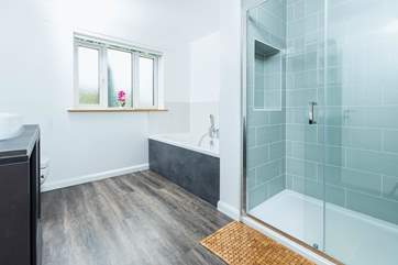 Bathroom 1 is beautifully created with both a walk-in shower and bath.