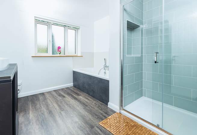 Bathroom 1 is beautifully created with both a walk-in shower and bath.