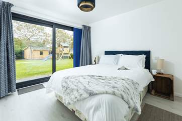 The main bedroom has a wonderful view of the garden, a fabulous king-size bed, en suite shower-room and walk-in dressing area.