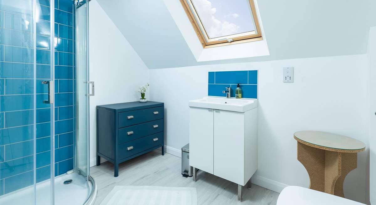 The en suite shower-room to bedroom 1 has a lovely corner shower and fills with natural light from the Velux window.