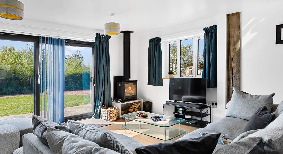 The fabulous living-room has a super-comfy corner sofa and patio doors to the garden.