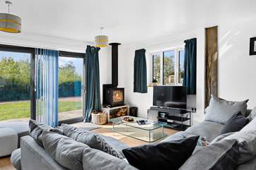 The fabulous living-room has a super-comfy corner sofa and patio doors to the garden.