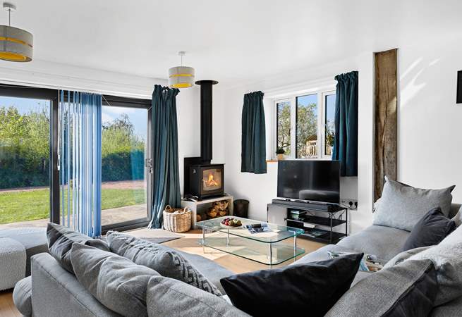 The fabulous living-room has a super-comfy corner sofa and patio doors to the garden.
