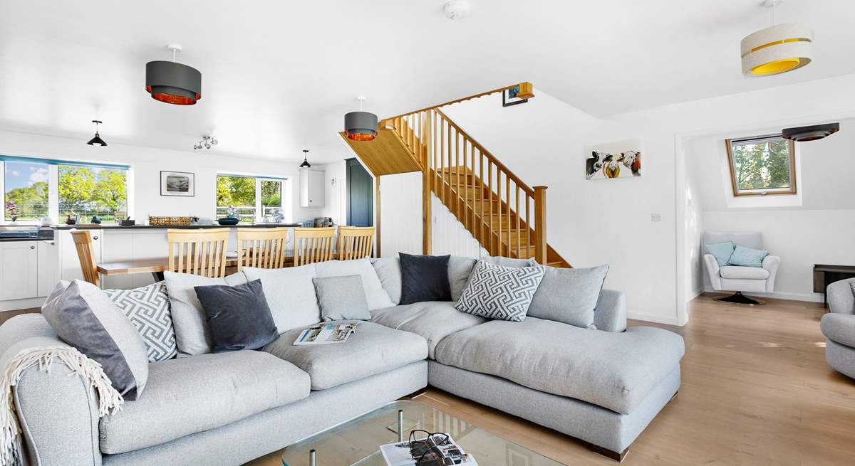 The relaxing living space with feature oak staircase.