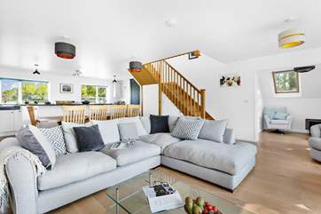The relaxing living space with feature oak staircase.