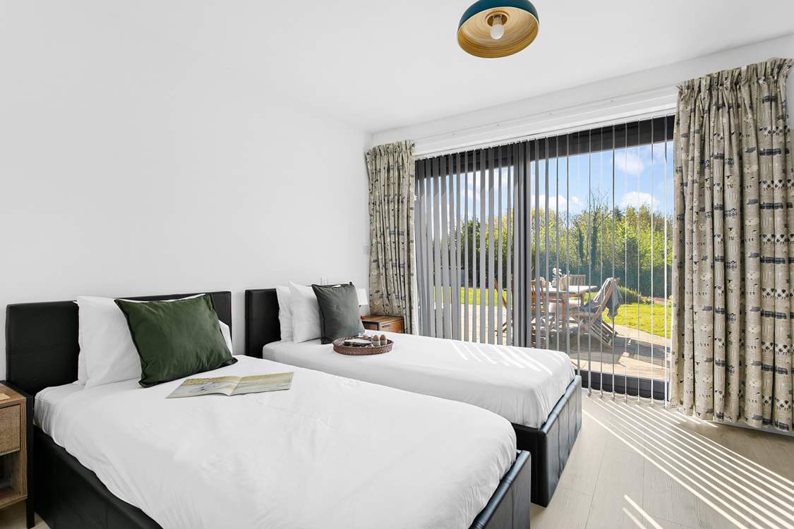The twin bedroom on the ground floor has access to the gardens through the patio doors, the perfect place for morning coffee.