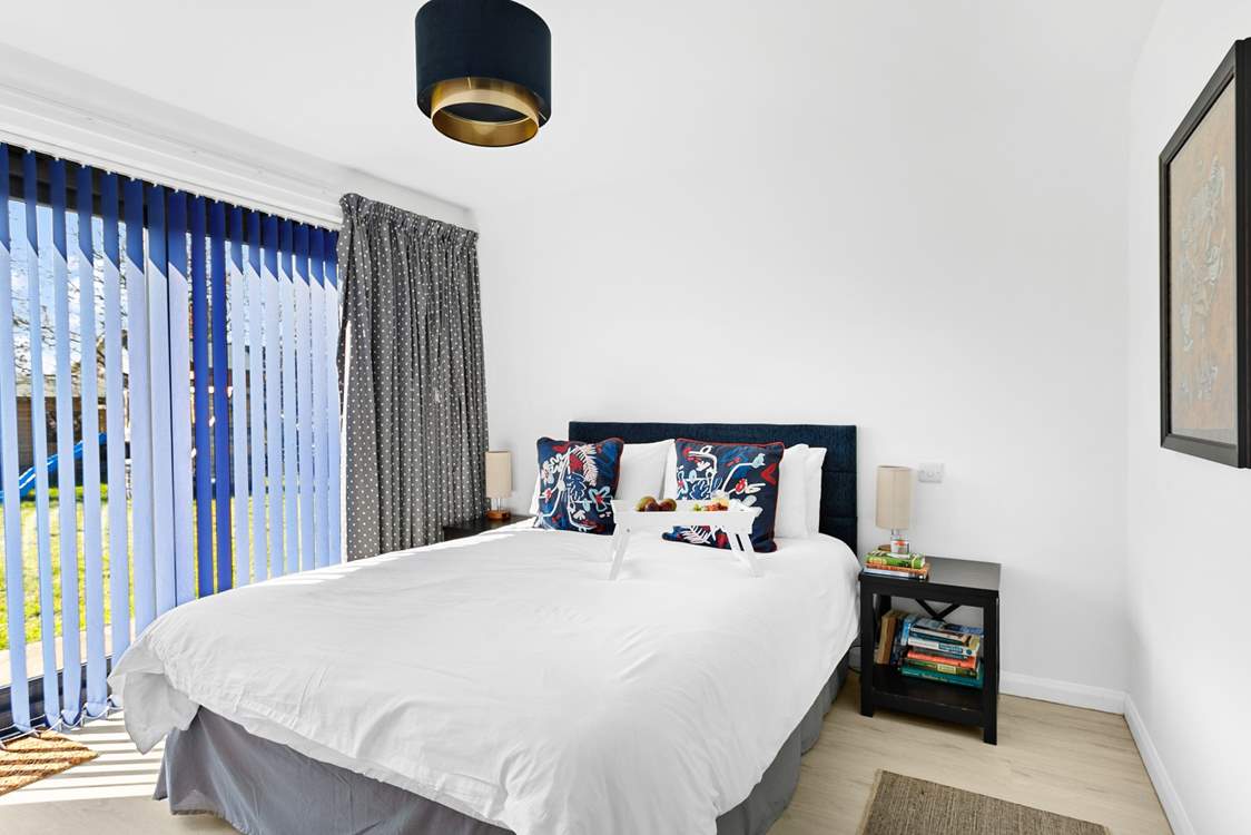 The main bedroom has a wonderful view of the garden, a fabulous king-size bed, en suite shower-room and walk-in dressing area.