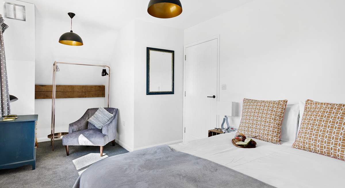 Bedroom 5 fills with light from the room length windows and is beautifully decorated in muted shades.