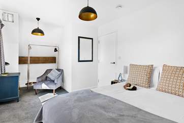 Bedroom 5 fills with light from the room length windows and is beautifully decorated in muted shades.