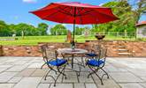 The patio at the rear of Walnut Barn has a lovely sunny aspect and overlooks nearby fields and woodland. - Thumbnail Image