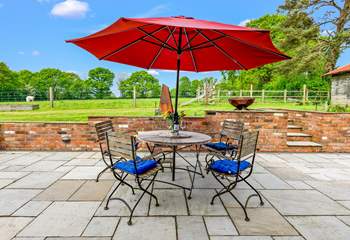 The patio at the rear of Walnut Barn has a lovely sunny aspect and overlooks nearby fields and woodland.