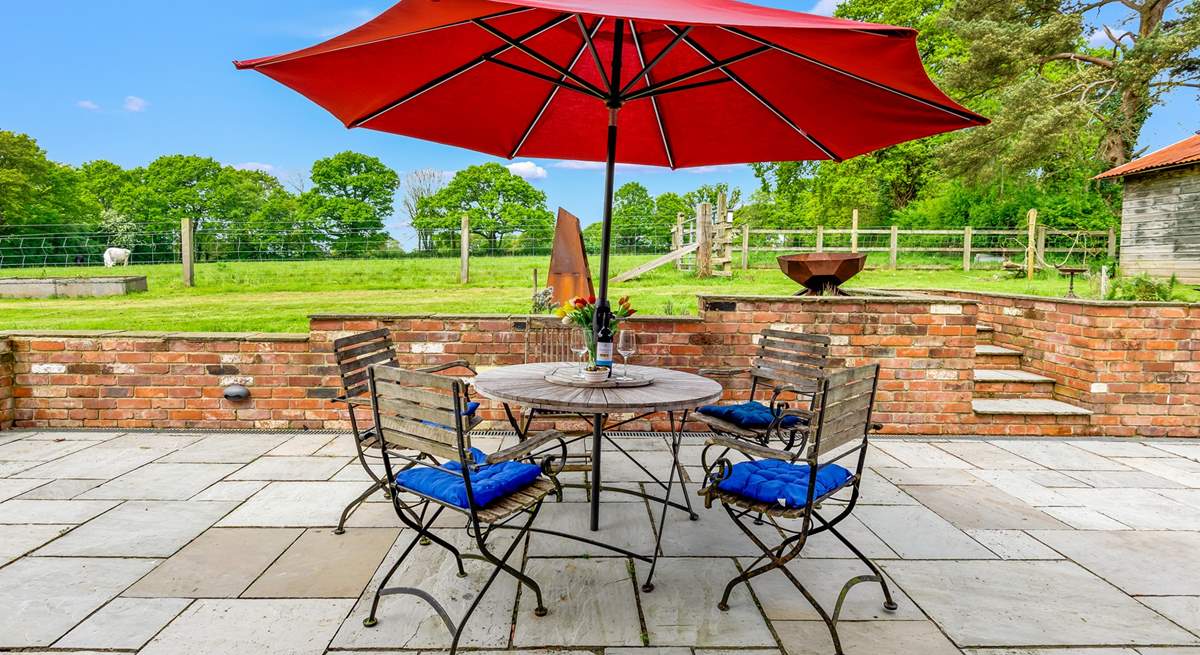 The patio at the rear of Walnut Barn has a lovely sunny aspect and overlooks nearby fields and woodland.