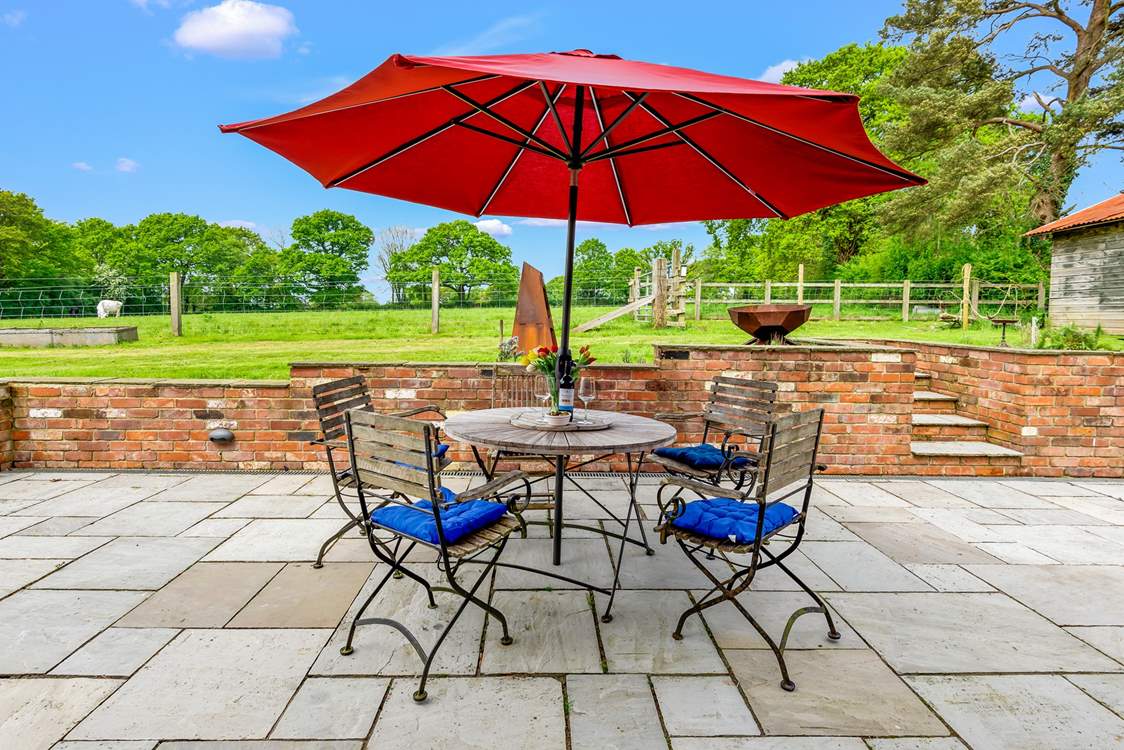 The patio at the rear of Walnut Barn has a lovely sunny aspect and overlooks nearby fields and woodland.