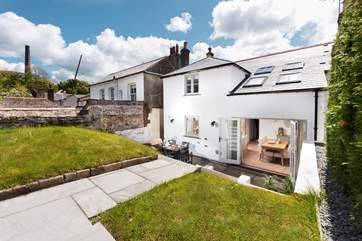 The large double doors open up onto the back garden with a further terrace for dining (there is a drop from the top lawned section to the lower terrace so please do not leave children unattended)