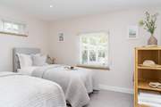 The second bedroom has two luxurious single beds.