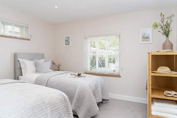 The second bedroom has two luxurious single beds.