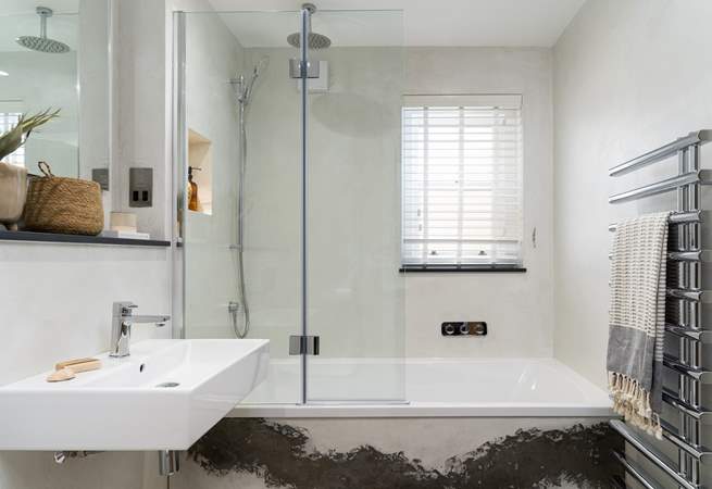 The light, modern family bathroom - the bath is perfect for soaking in after a day of exploring!