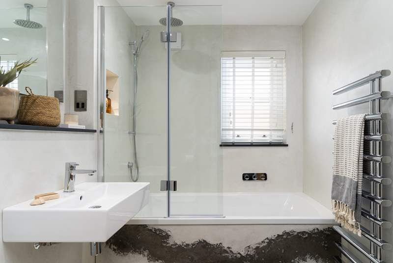 The light, modern family bathroom - the bath is perfect for soaking in after a day of exploring!