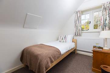 This sweet single bedroom looks out over the garden.