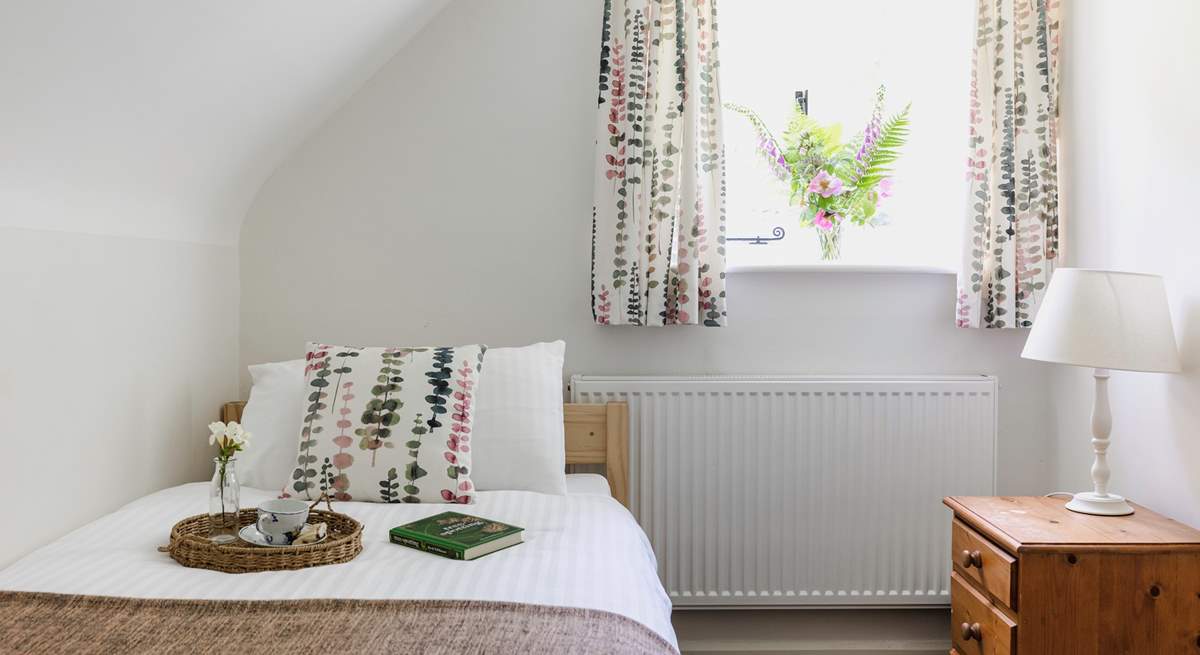 This sweet single bedroom looks out over the garden.