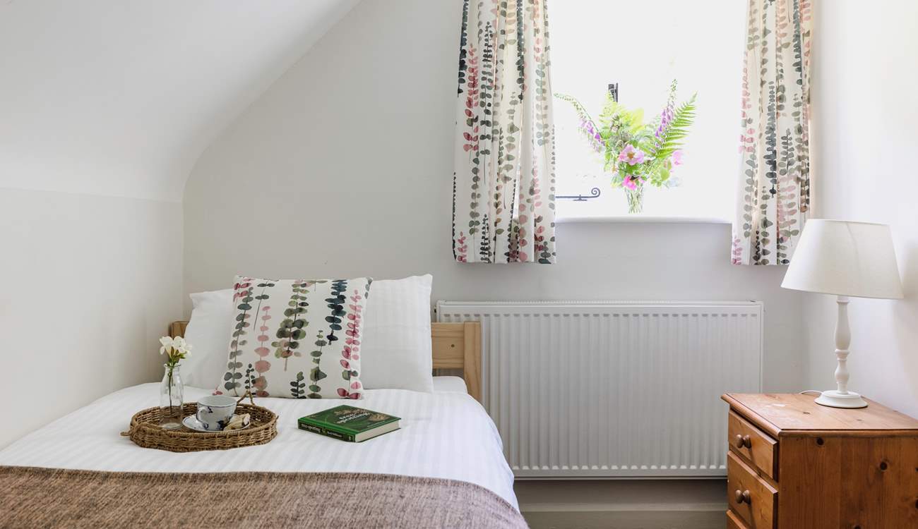 This sweet single bedroom looks out over the garden.