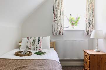 This sweet single bedroom looks out over the garden.