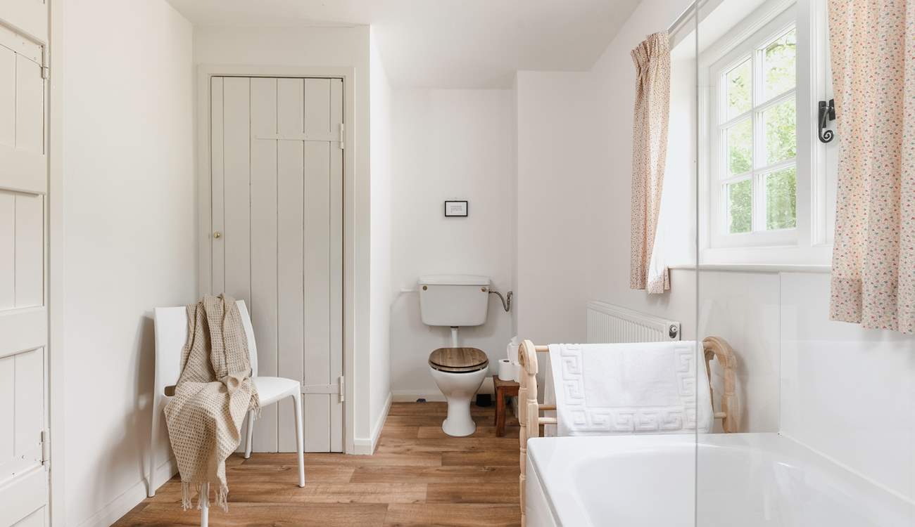 The recently refurbished bathroom looks out over rolling countryside.