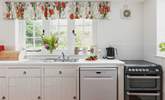 The farmhouse-style kitchen is split into two areas, with plenty of storage and worktop space in its totality. - Thumbnail Image