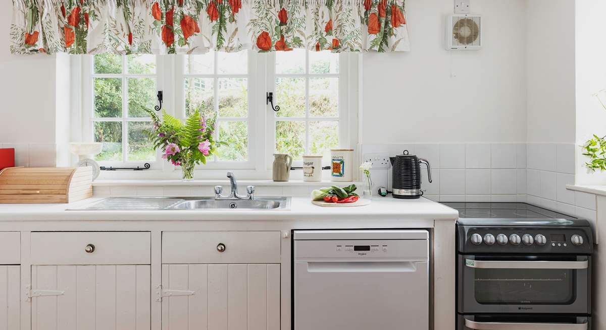 The farmhouse-style kitchen is split into two areas, with plenty of storage and worktop space in its totality.