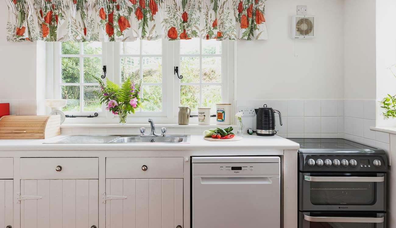 The farmhouse-style kitchen is split into two areas, with plenty of storage and worktop space in its totality.