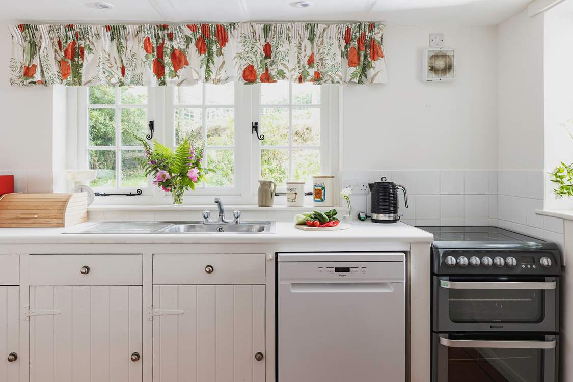The farmhouse-style kitchen is split into two areas, with plenty of storage and worktop space in its totality.