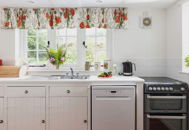 The farmhouse-style kitchen is split into two areas, with plenty of storage and worktop space in its totality.