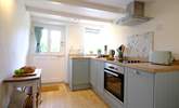 Beams and re-claimed wooden floorboards add character to the kitchen. - Thumbnail Image