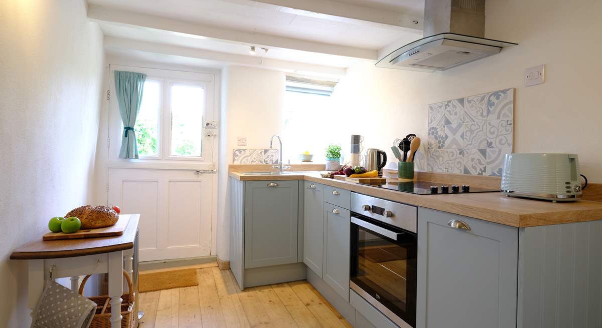 Beams and re-claimed wooden floorboards add character to the kitchen.