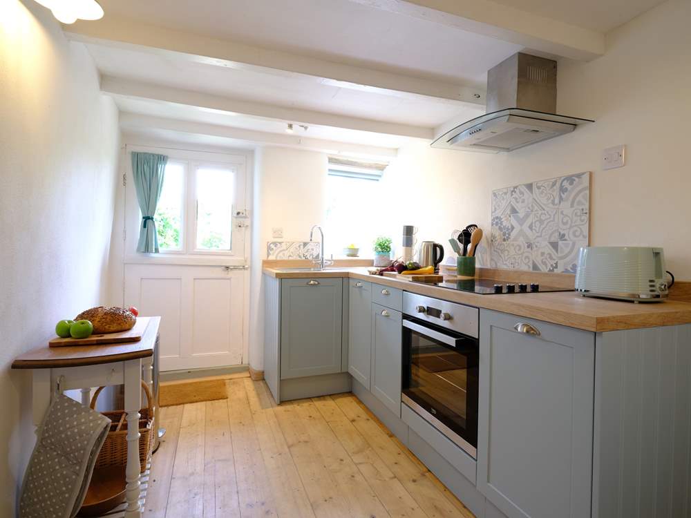 Beams and re-claimed wooden floorboards add character to the kitchen.