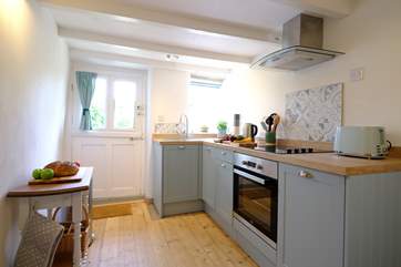 Beams and re-claimed wooden floorboards add character to the kitchen.