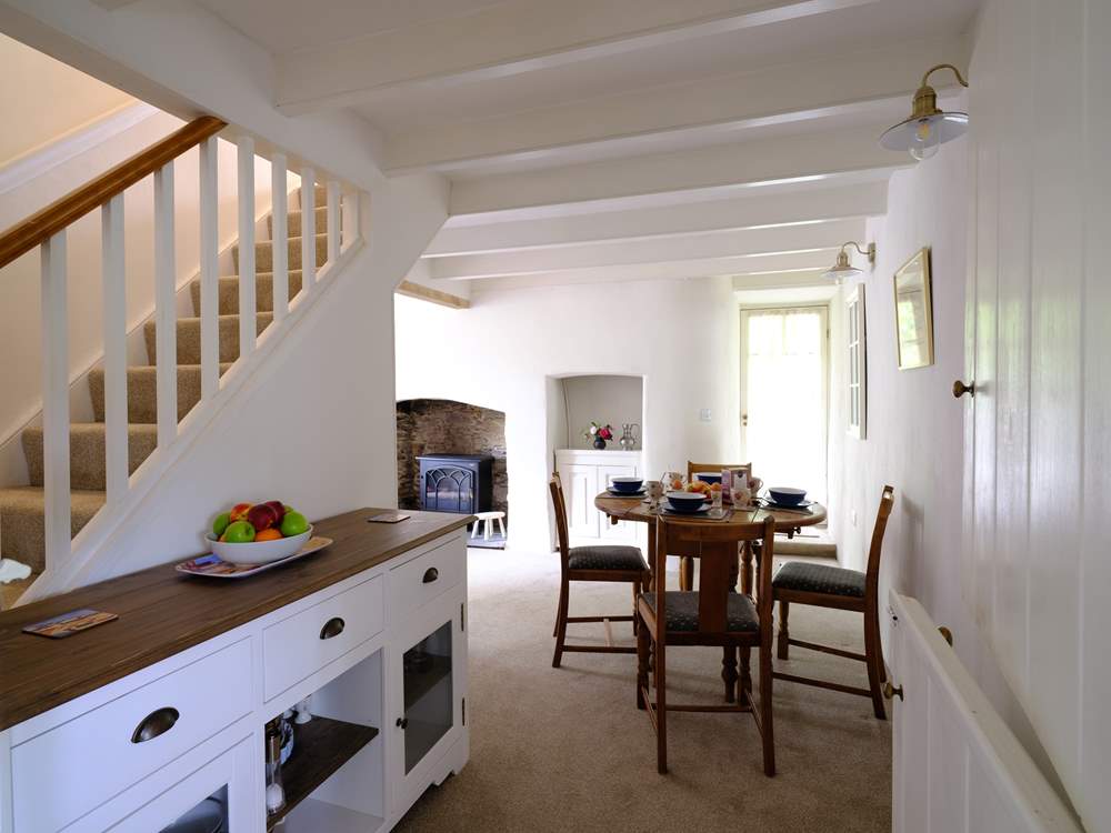 The dining area neatly links the sitting-room and kitchen.