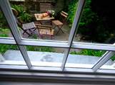 The secluded patio is a lovely place to sit at anytime of day.
